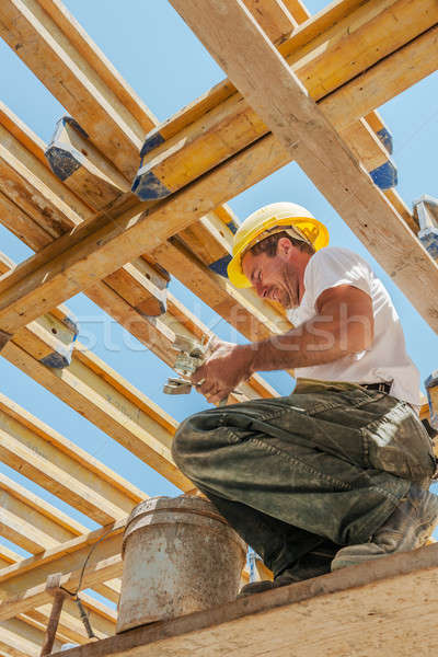 Smiling construction worker busy under slab formwork beams Stock photo © akarelias
