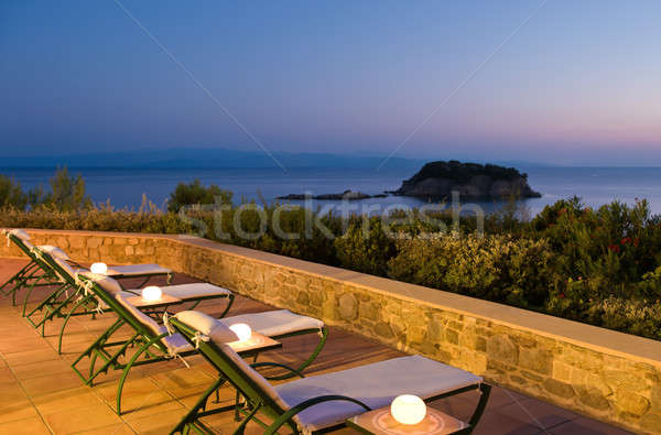 Deckchairs on verandah with great view Stock photo © akarelias