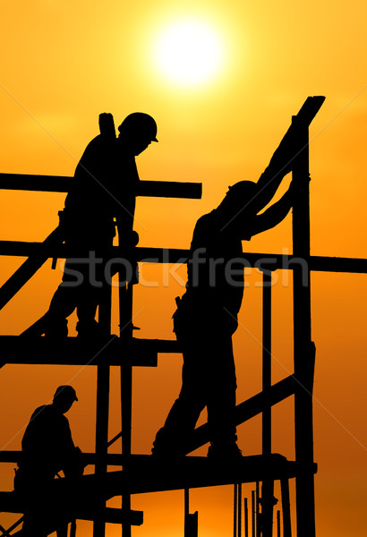 Construction workers under a hot blazing sun Stock photo © akarelias