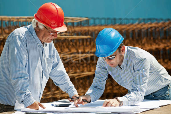 Young engineer and senior foreman Stock photo © akarelias