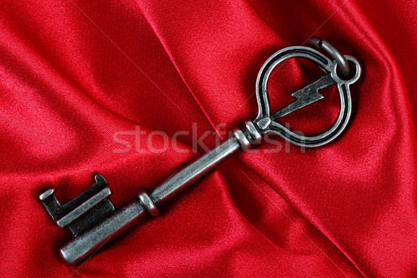 Old vintage key in red satin cloth background Stock photo © Akhilesh