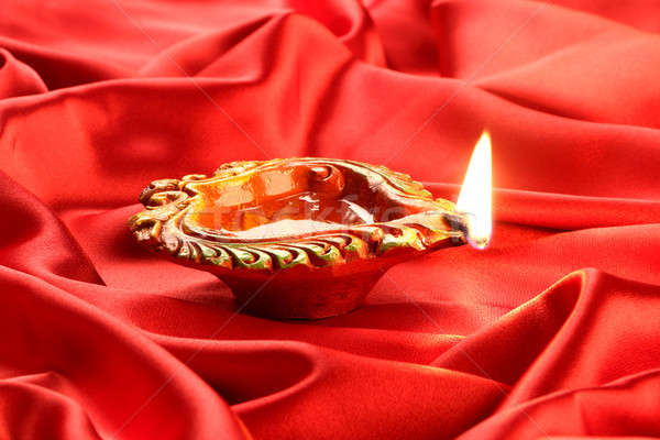 Feito à mão diwali argila lâmpada vermelho cetim Foto stock © Akhilesh