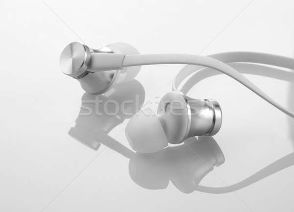 Earphones Headphones on Reflective White Background Stock photo © Akhilesh