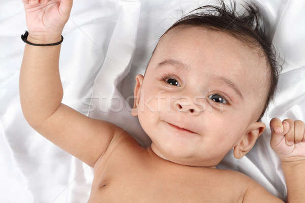 Smiling Baby on white satin background Stock photo © Akhilesh