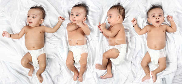 Baby in 4 different expressions on white satin background Stock photo © Akhilesh
