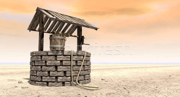 Stock photo: Wishing Well With Wooden Bucket On A Barren Landscape