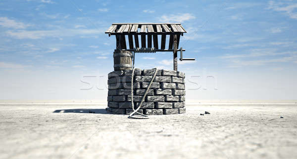 Wishing Well With Wooden Bucket On A Barren Landscape Stock photo © albund
