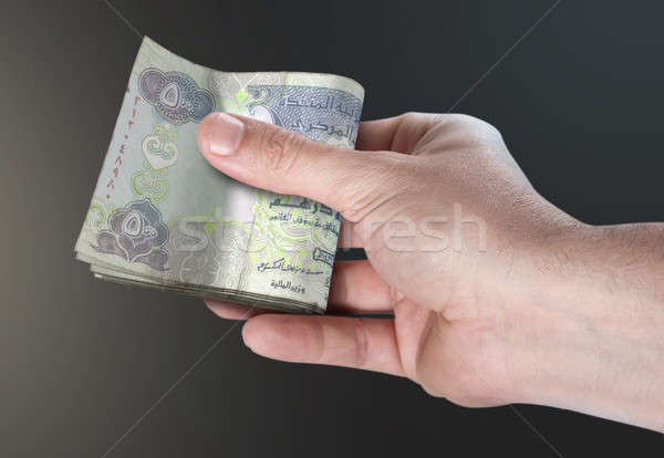 Hand Passing Wad Of Cash Stock photo © albund