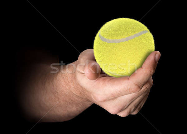 Mano palla da tennis maschio isolato buio Foto d'archivio © albund