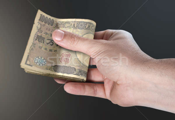 Hand Passing Wad Of Cash Stock photo © albund