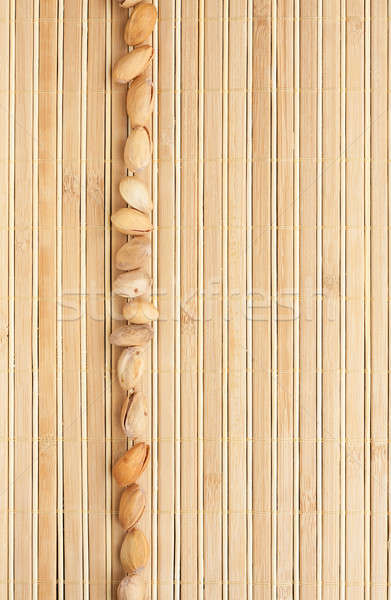 Cases a band of  pistachio  lying on bamboo mat Stock photo © alekleks