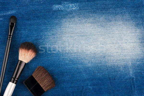 Three brushes for makeup lying on blue jeans Stock photo © alekleks