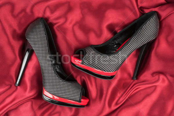 High-heeled shoes lying on red fabric Stock photo © alekleks