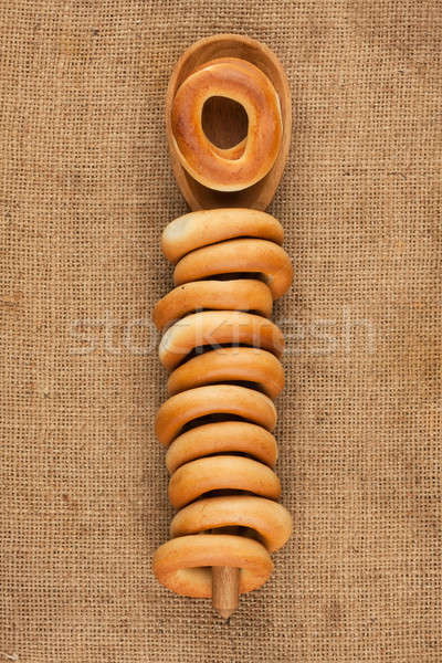 Wooden spoon with bagels lying on sackcloth Stock photo © alekleks