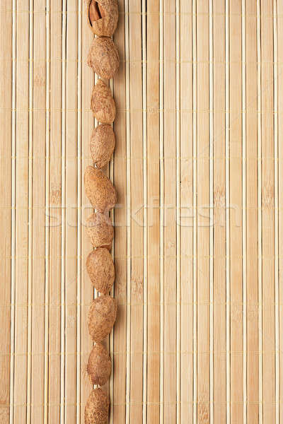 Cases a band of  almond  lying on bamboo mat Stock photo © alekleks