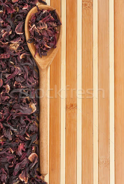 Spoon with dried hibiscus on a bamboo mat Stock photo © alekleks