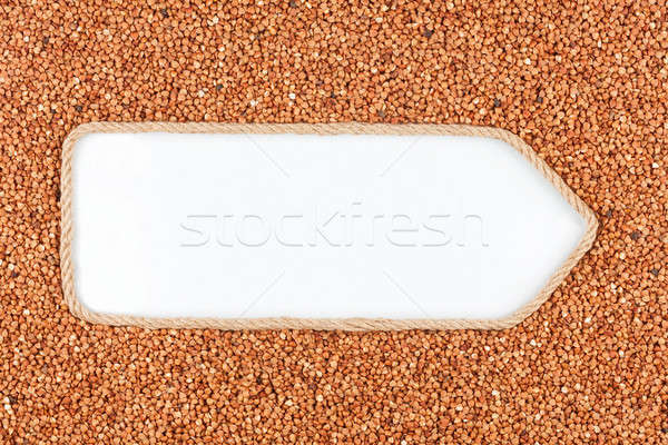 Pointer made from rope with grains buckwheat  lying on a white background Stock photo © alekleks
