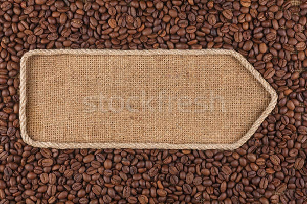 Stock photo: Pointer made from rope with coffee beans lying on sackcloth