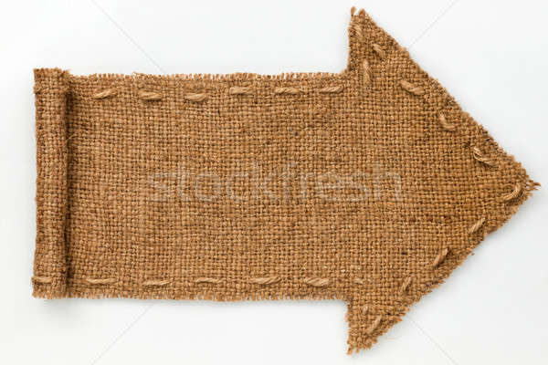 Arrow of burlap with curled edges lies on a white  background, Stock photo © alekleks