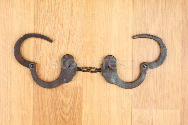 Opened  handcuffs lying on the wooden floor Stock photo © alekleks