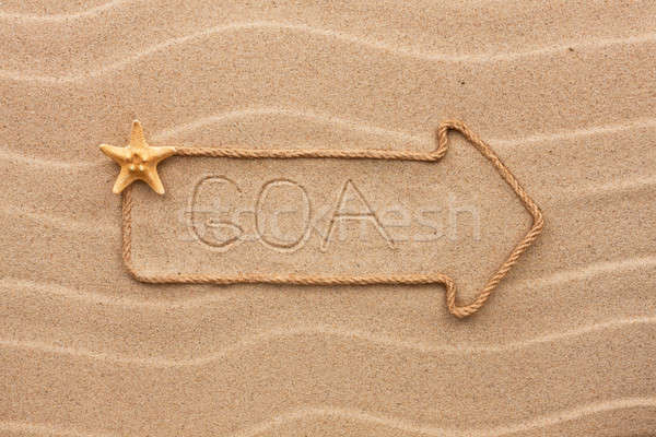 Arrow made of rope and sea shells with the word Goa on the sand Stock photo © alekleks
