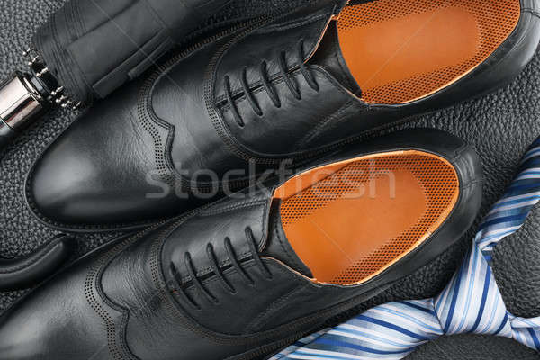 Classic men's shoes, tie, umbrella on the black leather Stock photo © alekleks