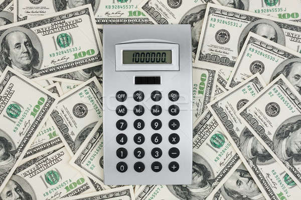 Background of $ 100 bills and a calculator  Stock photo © alekleks