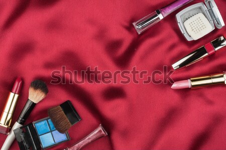 Beautiful picture of cosmetic  on red satin Stock photo © alekleks