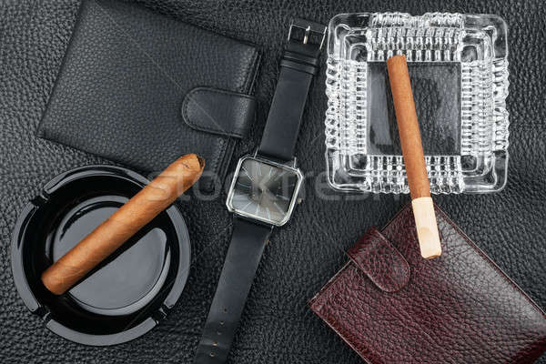Two ashtray with cigars, two purses and watches on the natural l Stock photo © alekleks