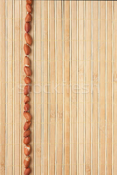 Cases a band of peanut lying on bamboo mat Stock photo © alekleks