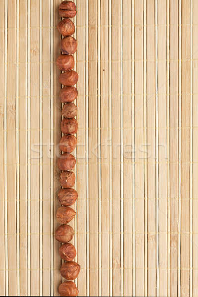 Cases a band of  hazelnut   lying on bamboo mat Stock photo © alekleks