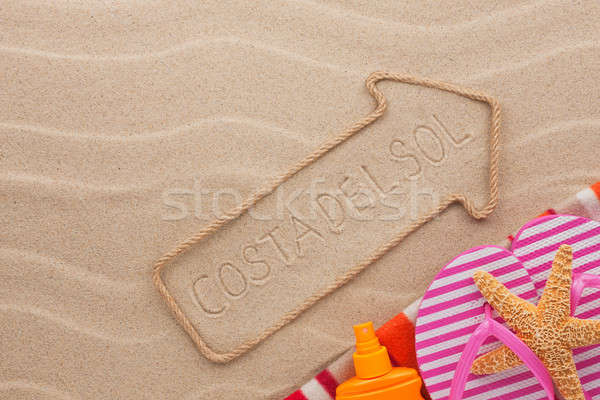 Costa del Sol pointer and beach accessories lying on the sand Stock photo © alekleks