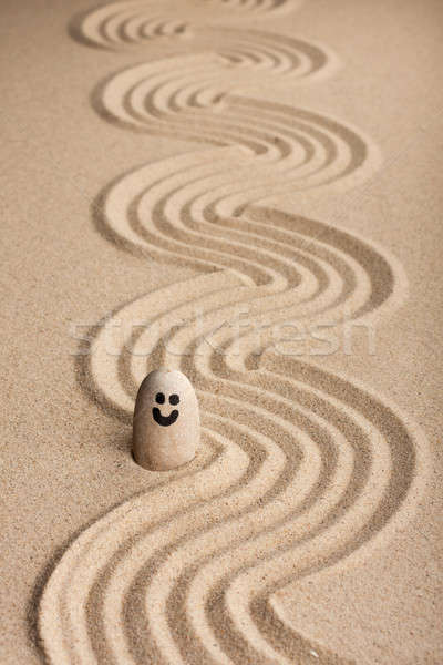 Stone smiley sticking out of the sand Stock photo © alekleks