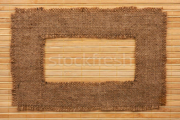 Frame made of burlap lying on a bamboo  mat Stock photo © alekleks