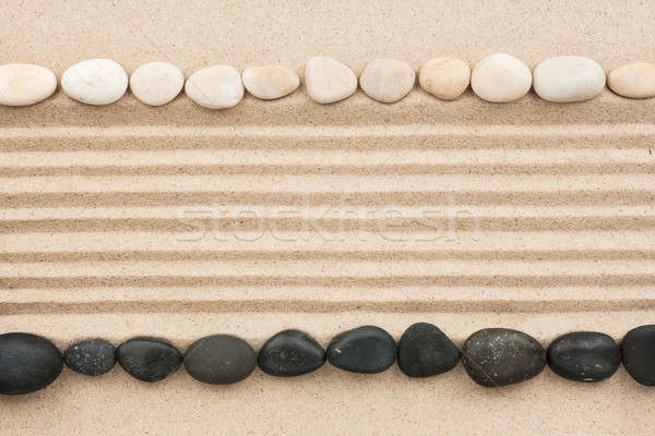 Black and white stones on sand Stock photo © alekleks