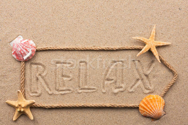 Arrow made of rope and sea shells with the word relax on the san Stock photo © alekleks