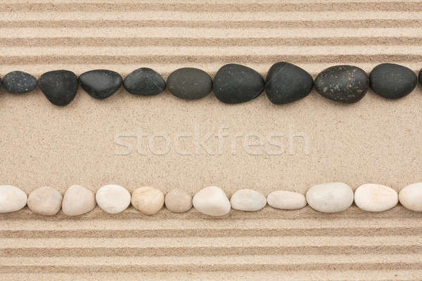 White and black stones lying on the sand Stock photo © alekleks