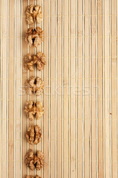 Cases a band of  walnut   lying on bamboo mat Stock photo © alekleks