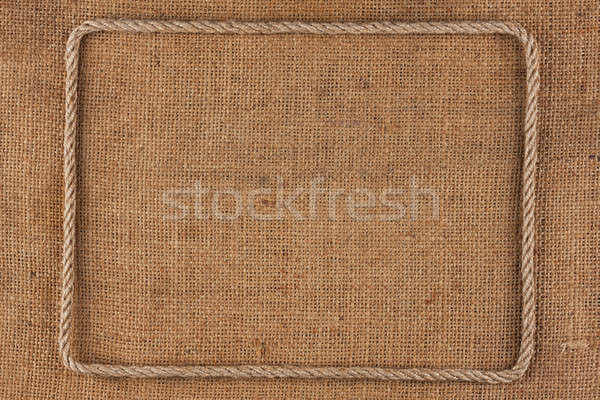 Stock photo: Frame of rope, lies on a background of burlap