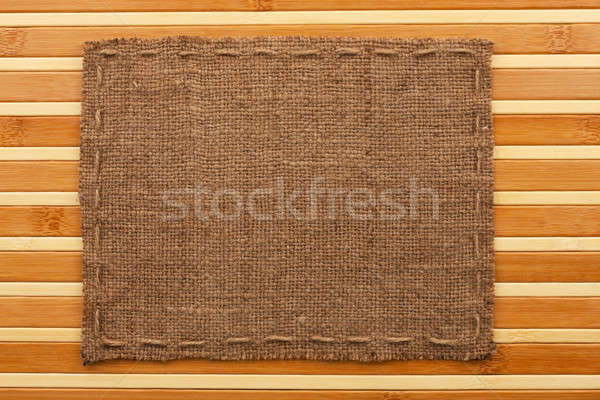 Frame of burlap, lies on a background of  bamboo mat Stock photo © alekleks