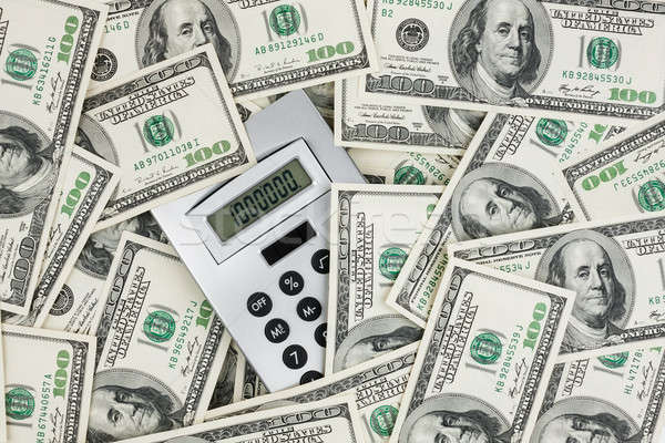Background of $ 100 bills and a calculator Stock photo © alekleks