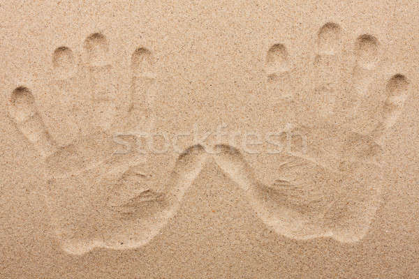 Imprint of two human hands in the sand Stock photo © alekleks