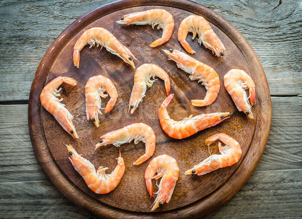 Raw shrimps on the wooden board Stock photo © Alex9500
