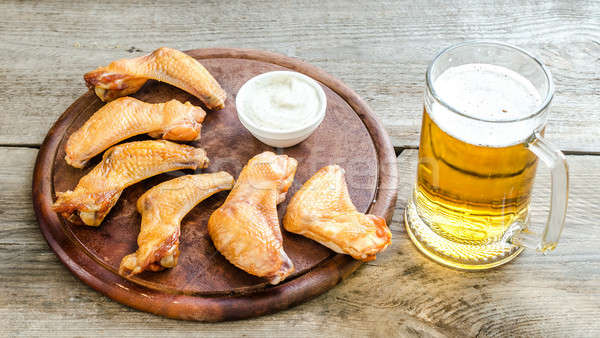 Smoked chicken wings with spicy sauce and glass of beer Stock photo © Alex9500