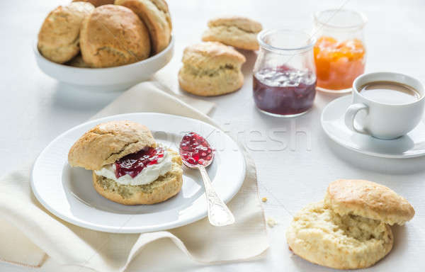 Scones with cream and fruit jam and cup of coffee Stock photo © Alex9500