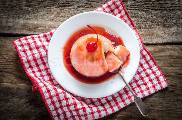 Panna cotta with berry sauce and maraschino cherry Stock photo © Alex9500