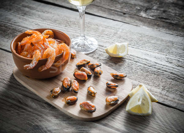 Stock photo: Fried shrimps and mussels with glass of white wine