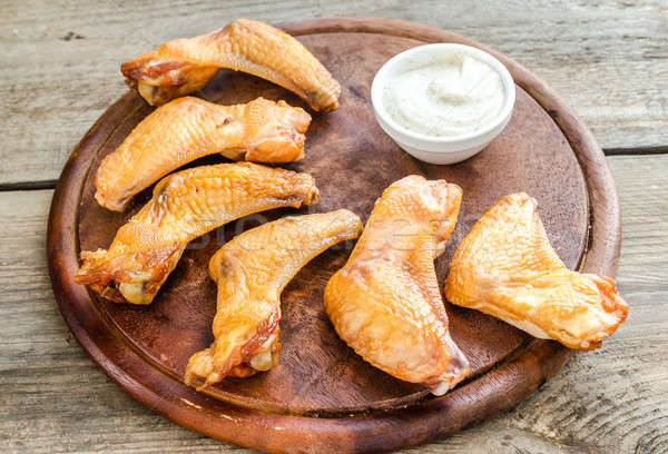 Stock photo: Smoked chicken wings with spicy sauce