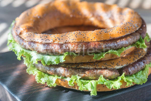 Bagels with fresh lettuce and fried sausage Stock photo © Alex9500