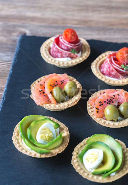 Tartlets with different fillings on the stone board Stock photo © Alex9500